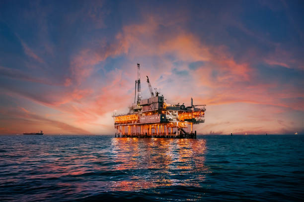 Offshore oil drilling platform at sunset